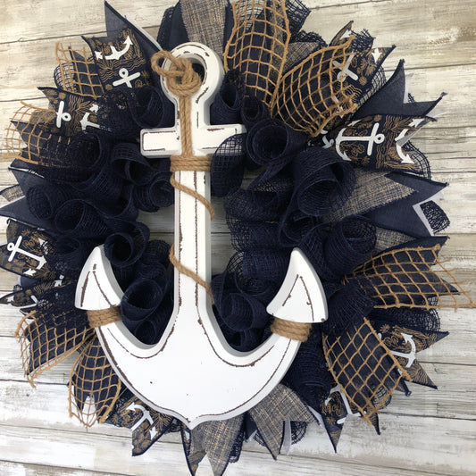 Nautical Anchor Door Wreath. Handmade Door Wreath. Anchors Away! This navy and white door wreath is rich in color and class. The white wood anchor pops off it’s navy backdrop and it is a must have addition to your home decor