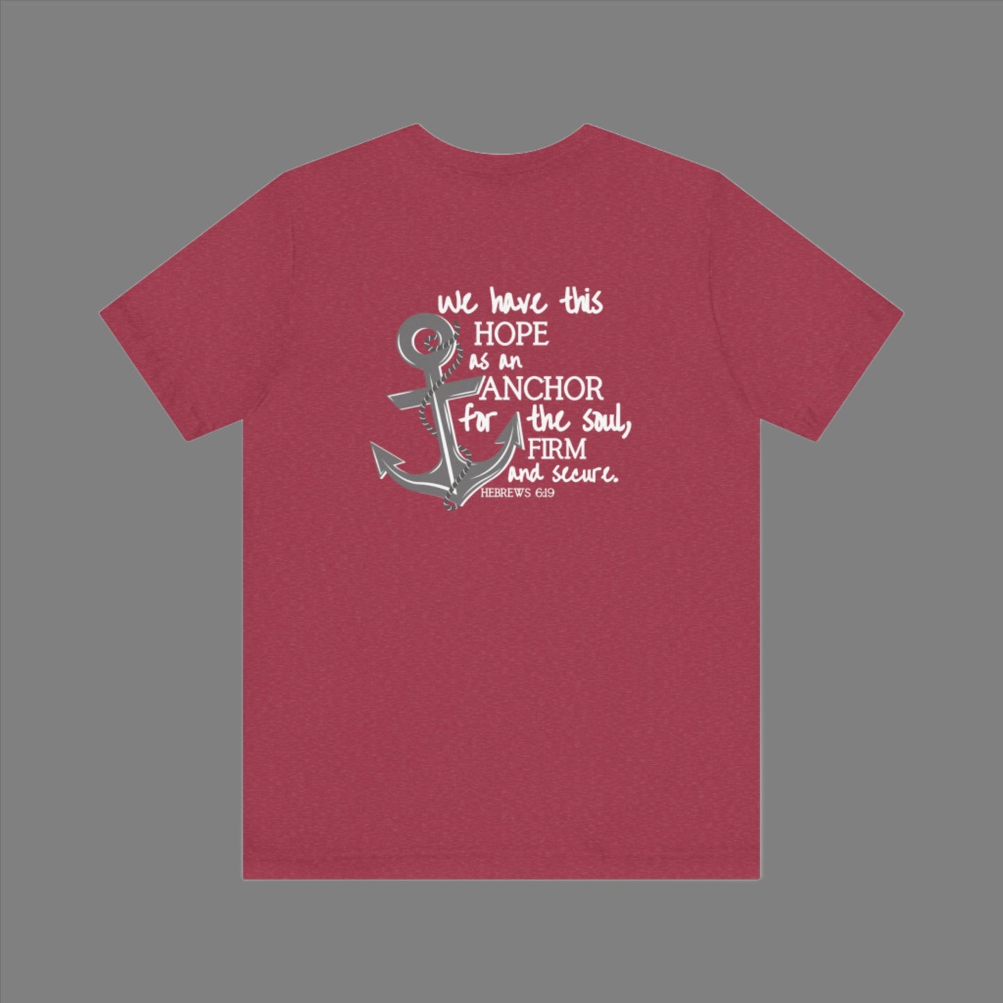 We have this hope as an anchor for the soul, firm and secure. Hebrews 6:19. This nautical Christian crewneck tee features a small anchor on the front with a large anchor and the Hebrews 6:19 bible verse in decorative font down the back. Cataldo Creations Christian Clothing, Christian T-Shirt, Christian Apparel. Bible Verse And Scripture Tees