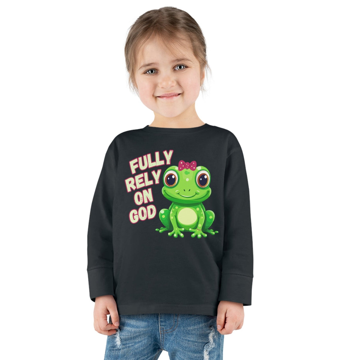 FROG. Fully Rely On God. This cute little girl toddler long sleeve t-shirt has an adorable green frog wearing a pink bow. Alongside are the words Fully Rely On God in light green and pink. Perfect for your toddler girl!