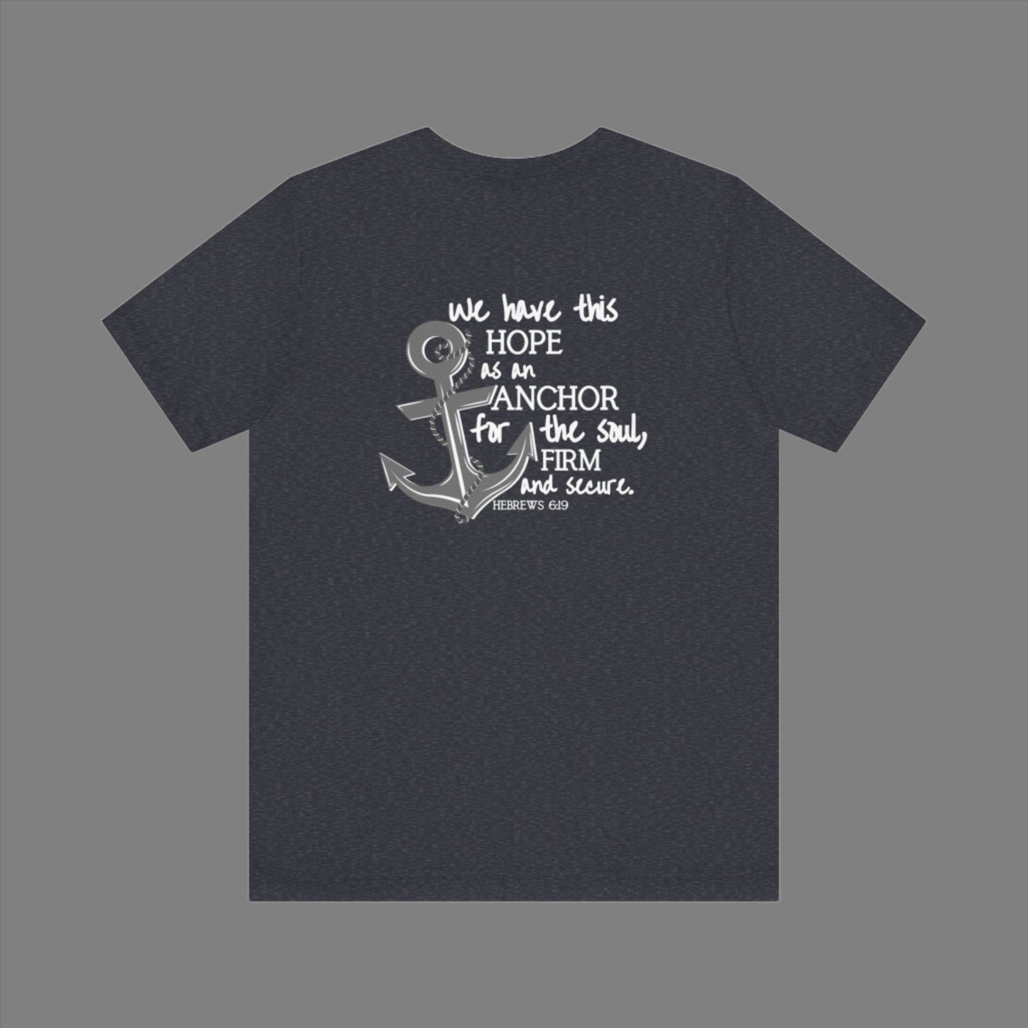 We have this hope as an anchor for the soul, firm and secure. Hebrews 6:19. This nautical Christian crewneck tee features a small anchor on the front with a large anchor and the Hebrews 6:19 bible verse in decorative font down the back. Cataldo Creations Christian Clothing, Christian T-Shirt, Christian Apparel. Bible Verse And Scripture Tees