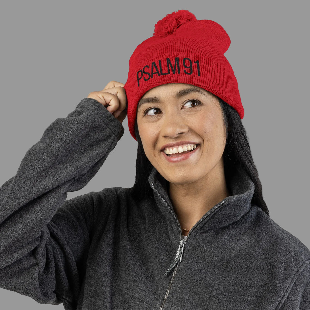 Person wearing a red beanie with 'PSALM 91' text on a white background
