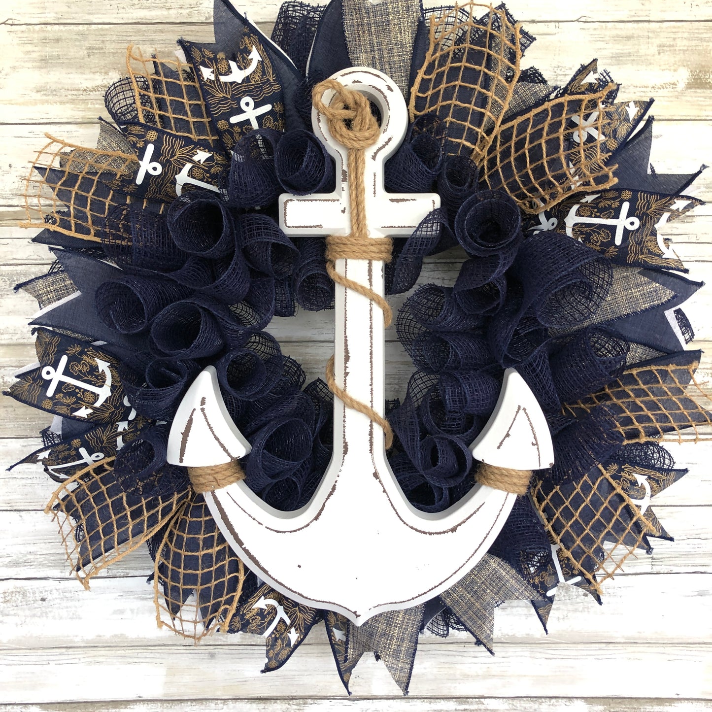 Nautical Anchor Door Wreath. Handmade Door Wreath. Anchors Away! This navy and white door wreath is rich in color and class. The white wood anchor pops off it’s navy backdrop and it is a must have addition to your home decor