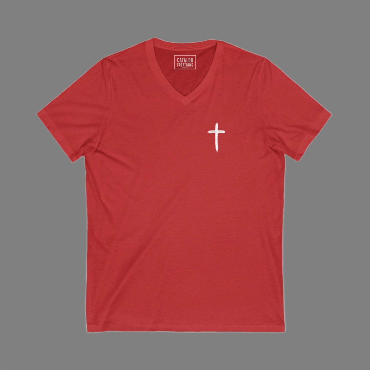 The 'Be Bold As A Lion' v-neck tee. The lion face pops with its gorgeous, lifelike markings throughout. In a big bold font, a reminder of God's word in Proverbs 28:1 from the Bible, to "Be Bold As A Lion". With a small cross on the front chest and available in different colors (and styles!) this t-shirt is one you will feel fearless wearing! Cataldo Creations Christian clothing. Faith Based apparel