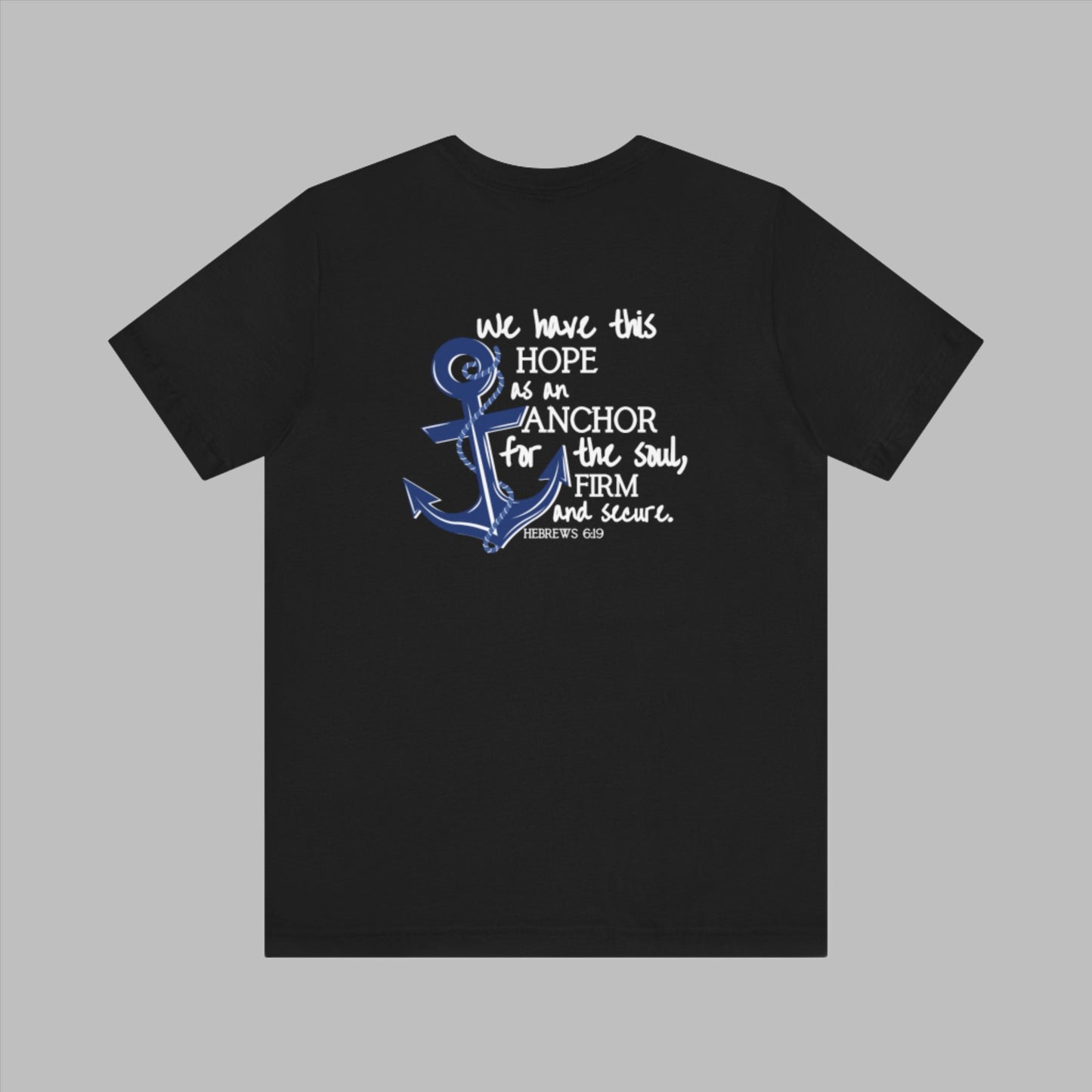 We have this hope as an anchor for the soul, firm and secure. Hebrews 6:19. This nautical Christian crewneck tee features a small anchor on the front with a large anchor and the Hebrews 6:19 bible verse in decorative font down the back. Cataldo Creations Christian Clothing, Christian T-Shirt, Christian Apparel. Bible Verse And Scripture Tees