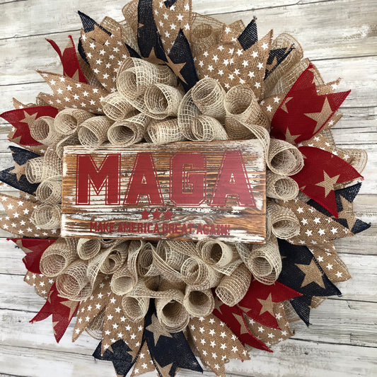 Show your patriotism and support for America with this handmade MAGA door wreath! Made with red, white, and blue star accent ribbon, it's the perfect addition to any porch or entryway. Let everyone know that you believe in making America great again! American Made. Patriot Made and one of a kind. 