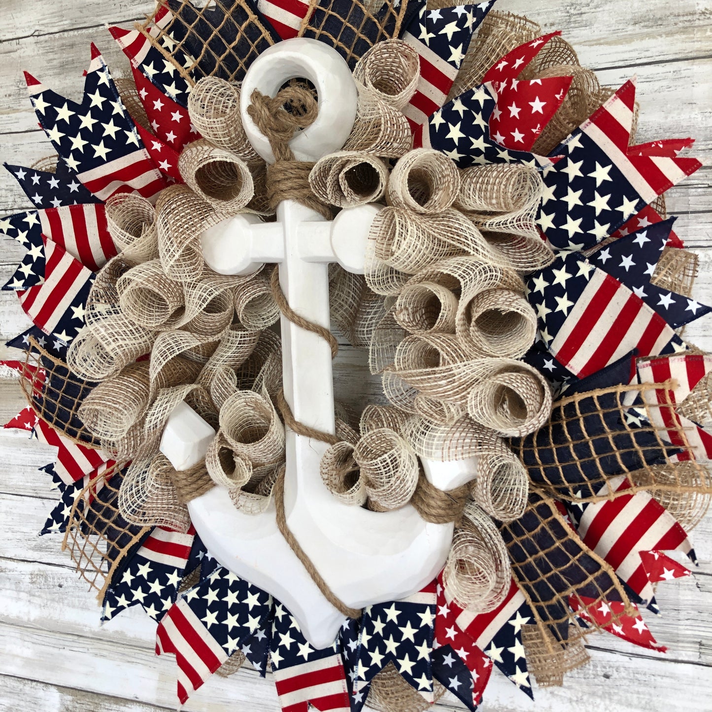 Nautical Anchor Door Wreath. Handmade Door Wreath. Anchors Away! This red, white and blue patriotic door wreath is the perfect wreath for the patriotic boater! The white wood anchor pops off its stars and stripes backdrop and it is a must have for your home.