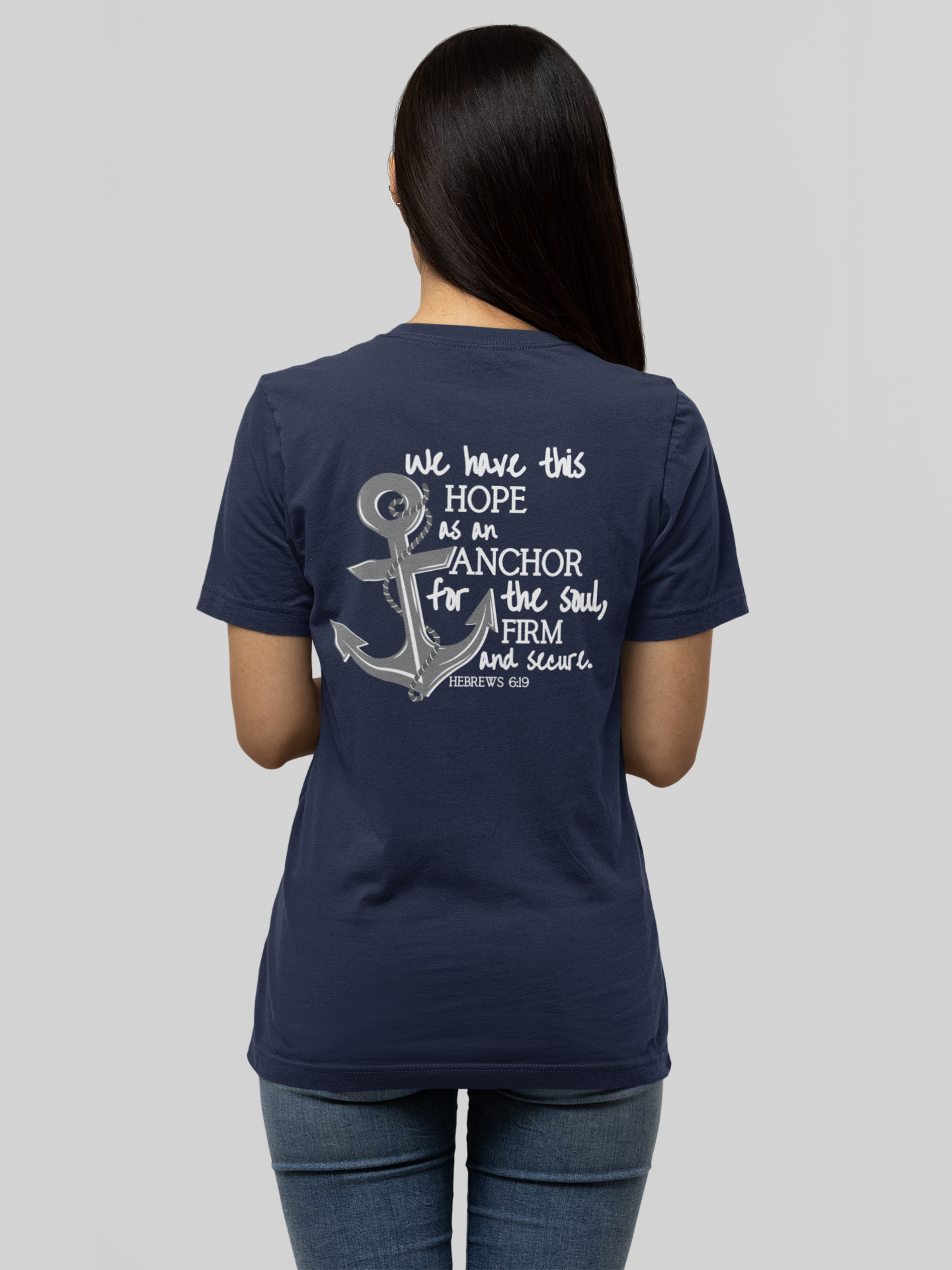 We have this hope as an anchor for the soul, firm and secure. Hebrews 6:19. This nautical Christian crewneck tee features a small anchor on the front with a large anchor and the Hebrews 6:19 bible verse in decorative font down the back. Cataldo Creations Christian Clothing, Christian T-Shirt, Christian Apparel. Bible Verse And Scripture Tees