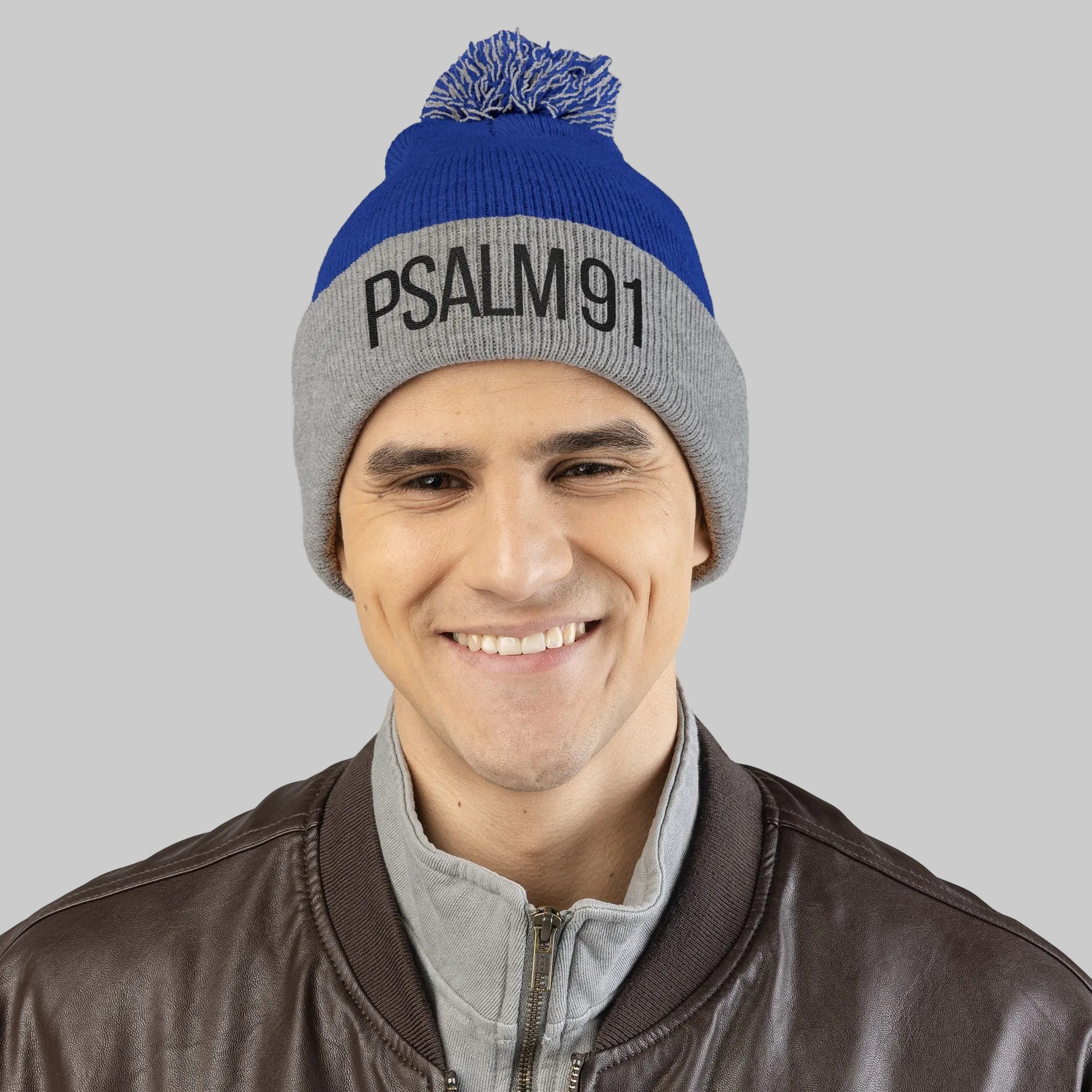 Man wearing a blue and gray beanie with 'PSALM 91' text on a white background