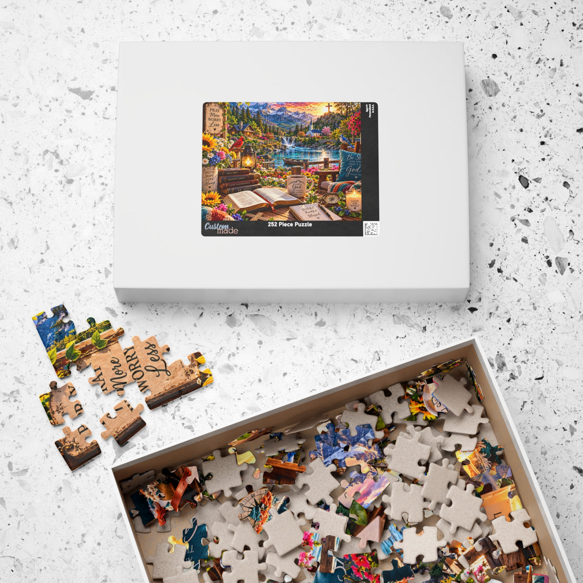 Christian Bible verse jigsaw puzzle featuring a mountain lake, waterfall, chapel, colorful flowers, open Bible, and Pray More Worry Less faith-inspired artwork.