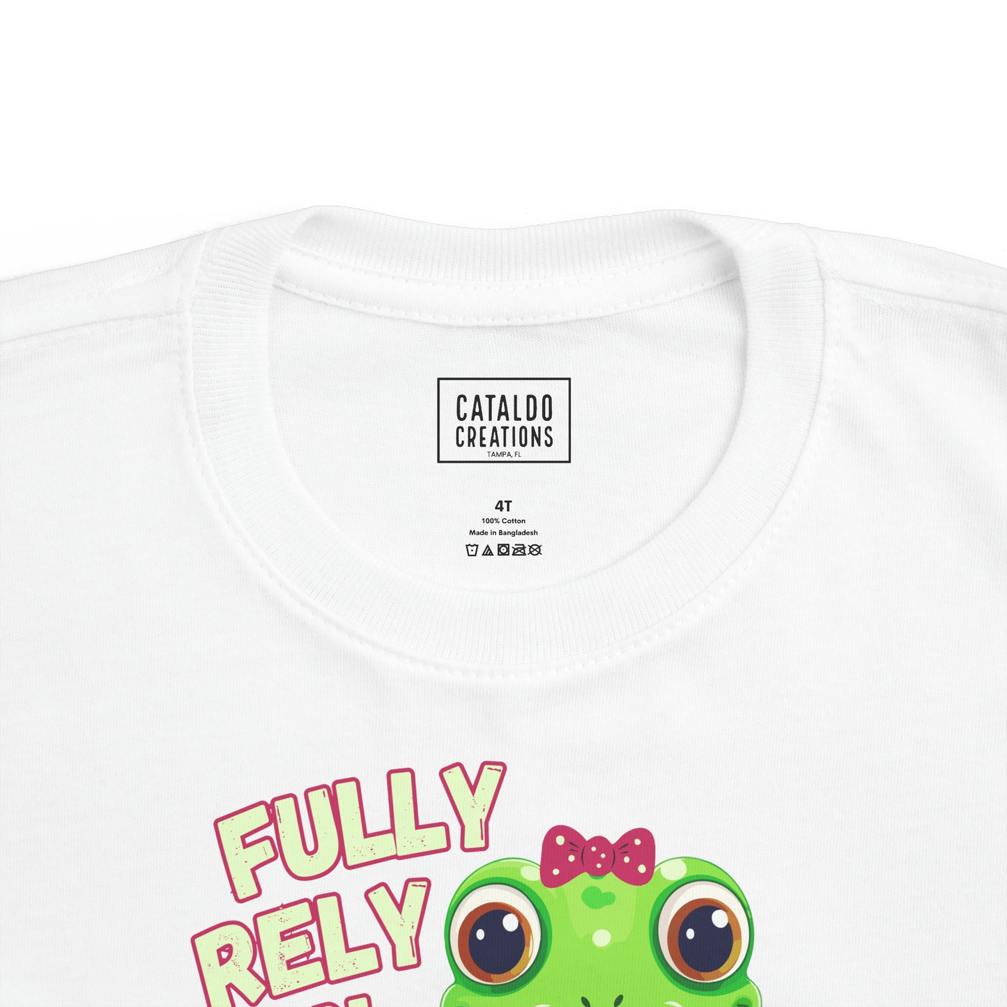 FROG. Fully Rely On God. This cute little girl toddler short sleeve t-shirt has an adorable green frog wearing a pink bow.&nbsp; Alongside are the words Fully Rely On God in light green and pink lettering. Perfect for your toddler girl! Christian toddler tee. Cataldo Creations apparel for toddlers