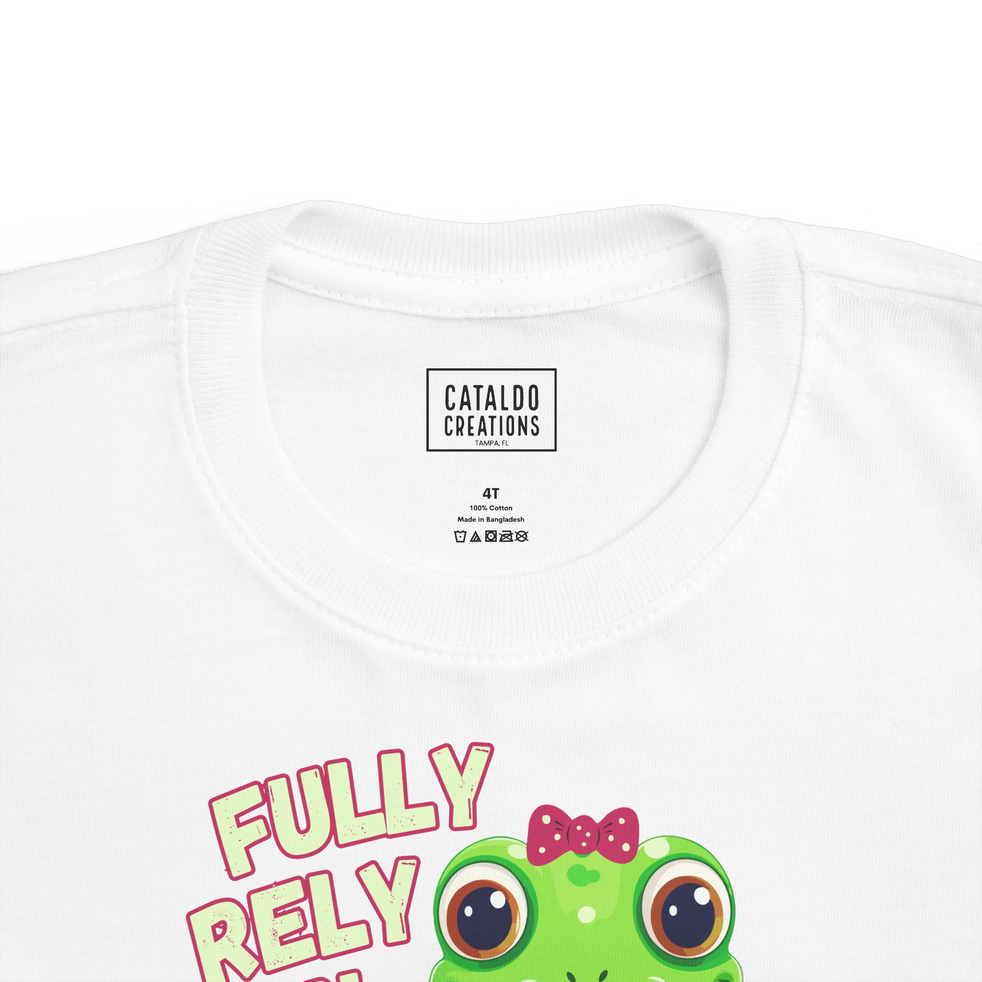 FROG. Fully Rely On God. This cute little girl toddler short sleeve t-shirt has an adorable green frog wearing a pink bow.&nbsp; Alongside are the words Fully Rely On God in light green and pink lettering. Perfect for your toddler girl! Christian toddler tee. Cataldo Creations apparel for toddlers