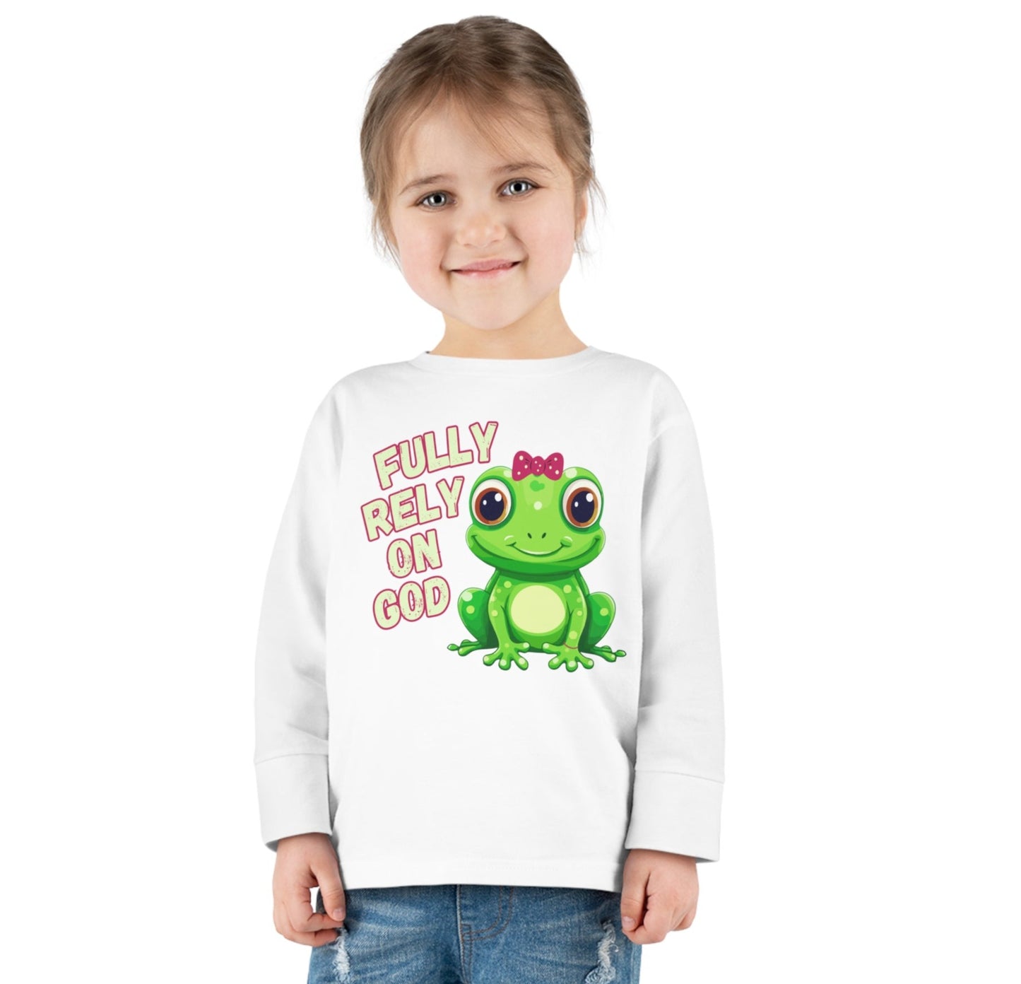 FROG. Fully Rely On God. This cute little girl toddler long sleeve t-shirt has an adorable green frog wearing a pink bow.  Alongside are the words Fully Rely On God in light green and pink.  Perfect for your toddler girl! 