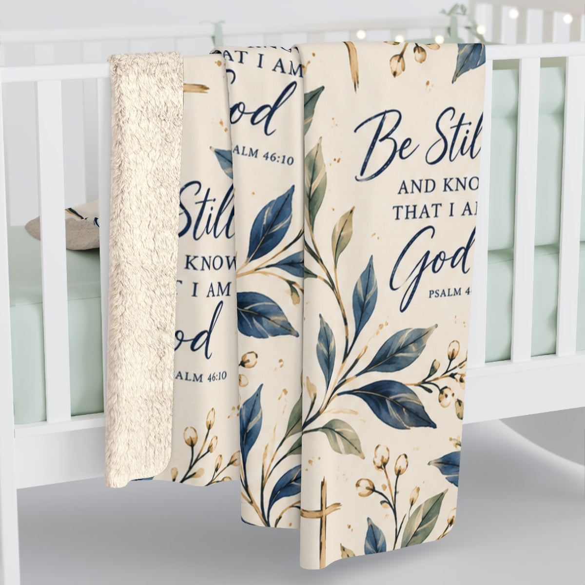Be Still and Know Psalm 46:10 Christian sherpa blanket design featuring navy Scripture lettering, watercolor botanical leaves, gold crosses and an ivory background.