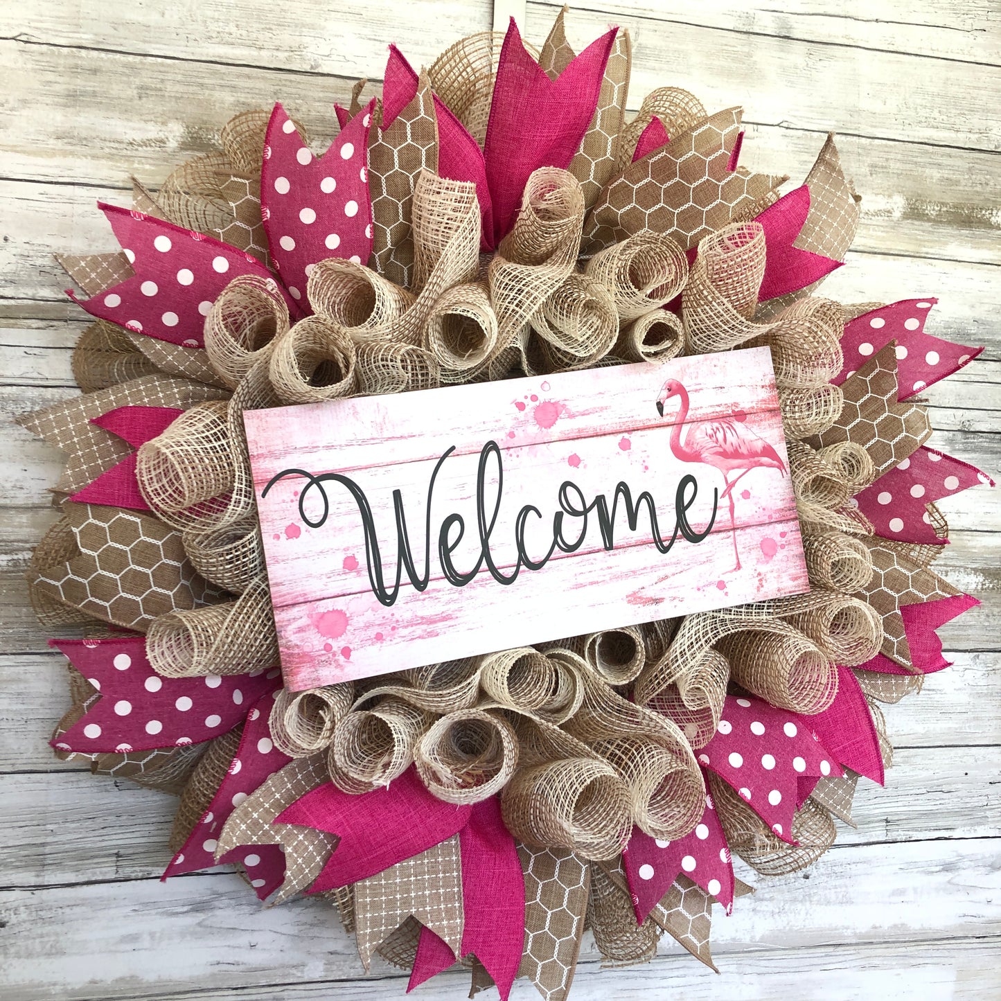 Welcome guests to your home with a touch of whimsy and warmth with our Flamingo Pink Welcome Door Wreath! Featuring a charming flamingo design and delicate pink and beige accents, this handmade wreath is the perfect way to make your entrance inviting.