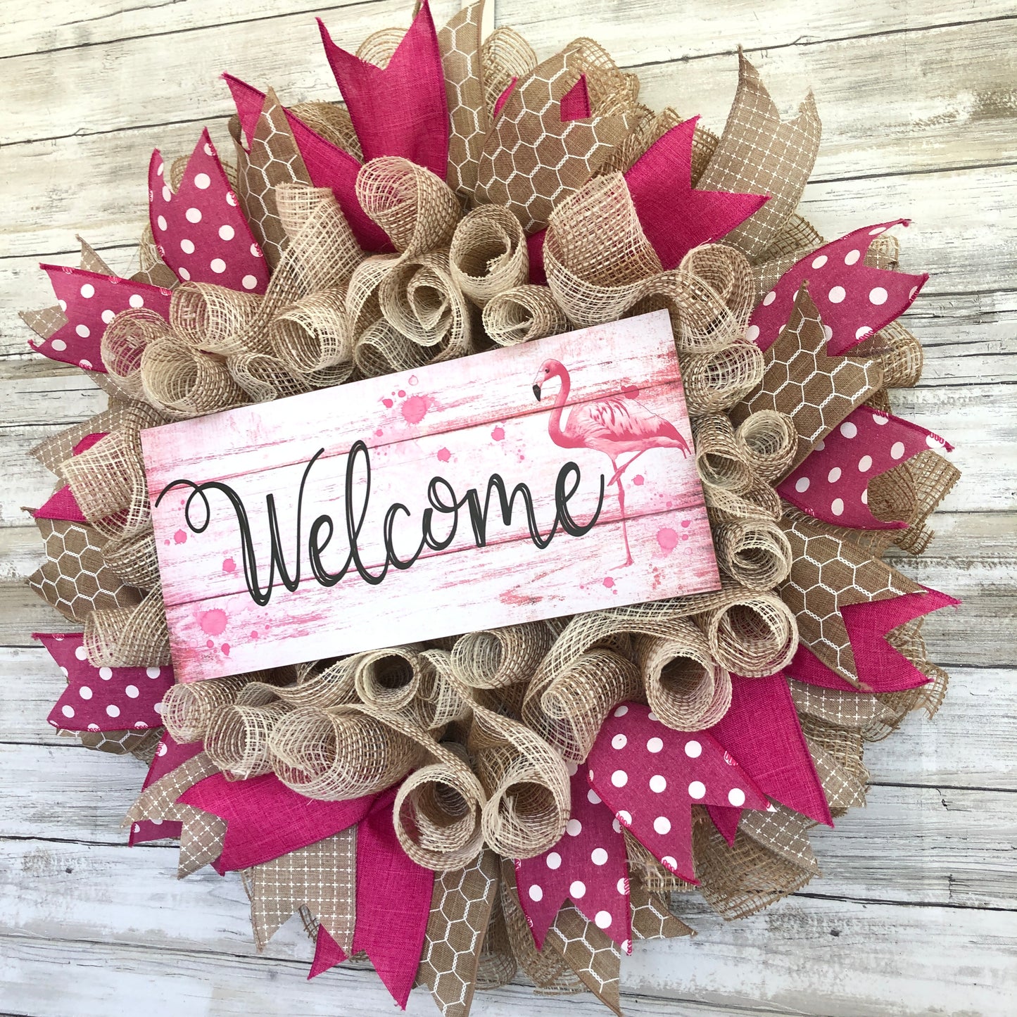 Welcome guests to your home with a touch of whimsy and warmth with our Flamingo Pink Welcome Door Wreath! Featuring a charming flamingo design and delicate pink and beige accents, this handmade wreath is the perfect way to make your entrance inviting.