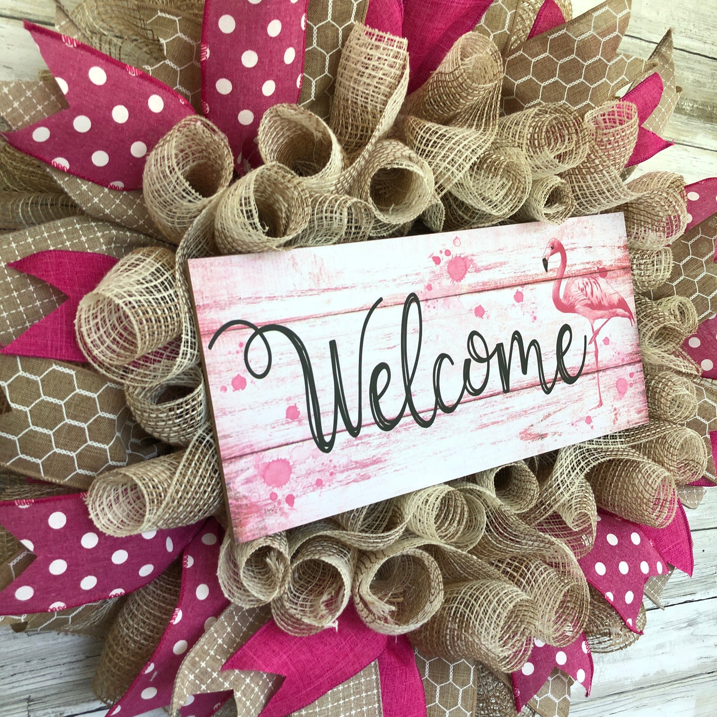 Welcome guests to your home with a touch of whimsy and warmth with our Flamingo Pink Welcome Door Wreath! Featuring a charming flamingo design and delicate pink and beige accents, this handmade wreath is the perfect way to make your entrance inviting.