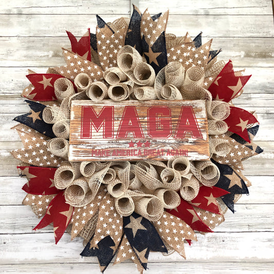 Show your patriotism and support for America with this handmade MAGA door wreath! Made with red, white, and blue star accent ribbon, it's the perfect addition to any porch or entryway. Let everyone know that you believe in making America great again!  American Made. Patriot Made and one of a kind.&nbsp;