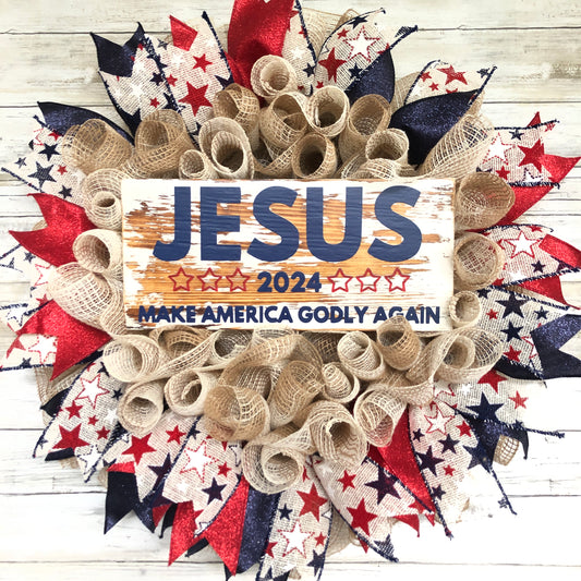 Celebrate your faith and patriotism with this handmade door wreath featuring the message "Jesus 2024 Make America Godly Again." The vibrant blue and red glitter ribbon add a festive touch. Show your support for a godly America in the upcoming election.