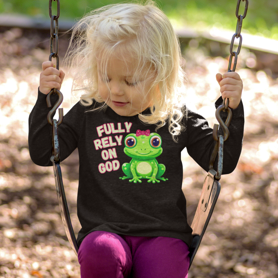 FROG. Fully Rely On God. This cute little girl toddler long sleeve t-shirt has an adorable green frog wearing a pink bow.  Alongside are the words Fully Rely On God in light green and pink.  Perfect for your toddler girl! 