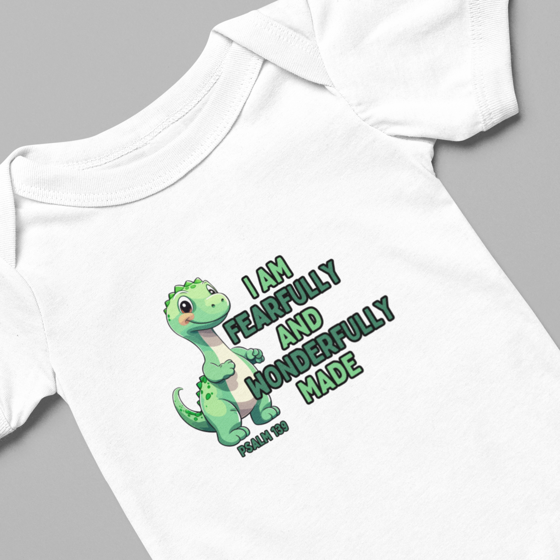 Introduce your little one to the world with our Fearfully Made Green Dinosaur Infant Bodysuit Onesie. Featuring a bible verse from psalm 139:14, this bodysuit reminds us that we are all fearfully and wonderfully made. Made for infants, this bodysuit is both comfortable and meaningful.